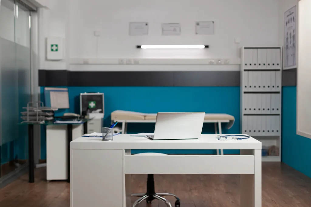 empty doctors workplace room with desk technology